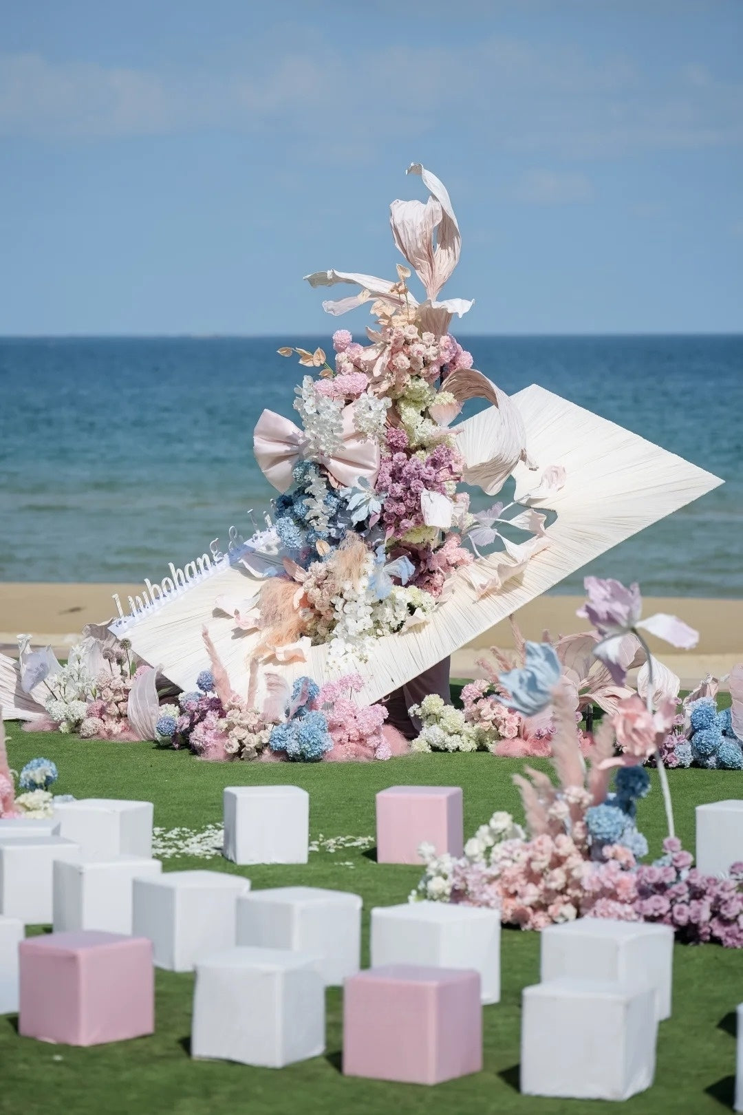 Oceanfront Wedding Inspiration with Soft Pink Draping and Pastel Floral Details