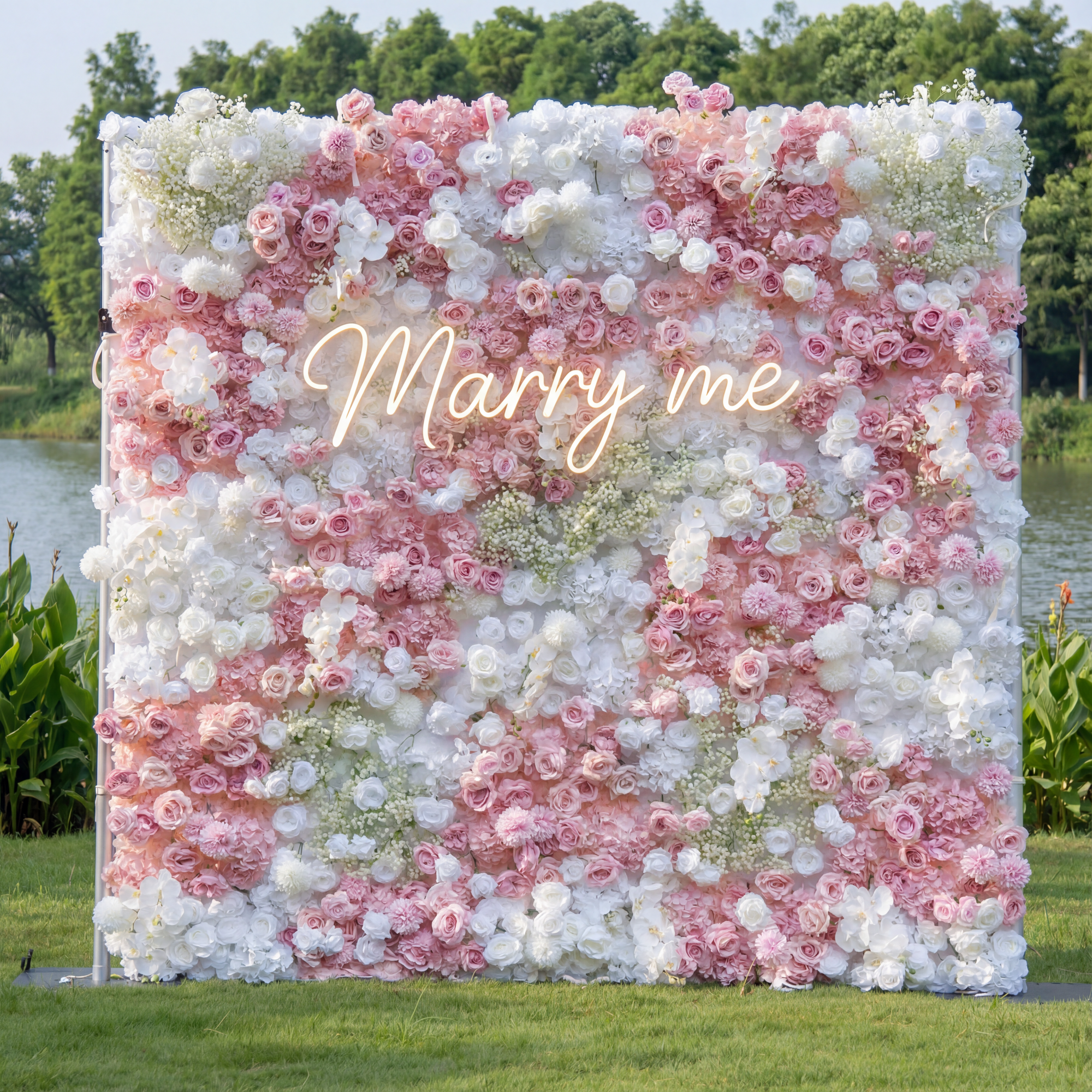 Floral wall with 'Marry me' sign in a natural setting