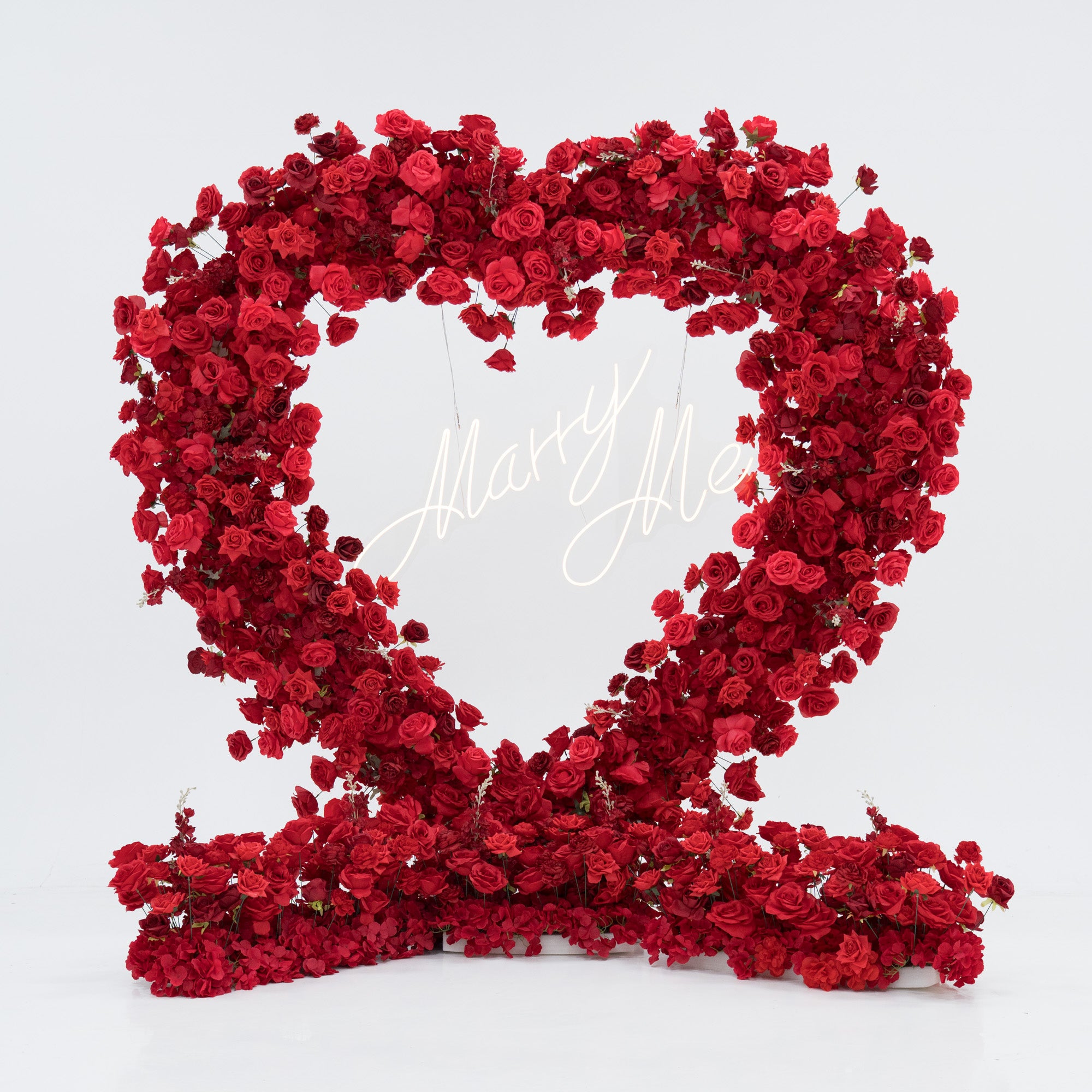 Red rose heart-shaped arrangement with 'Happy Valentine's Day' text on a white background