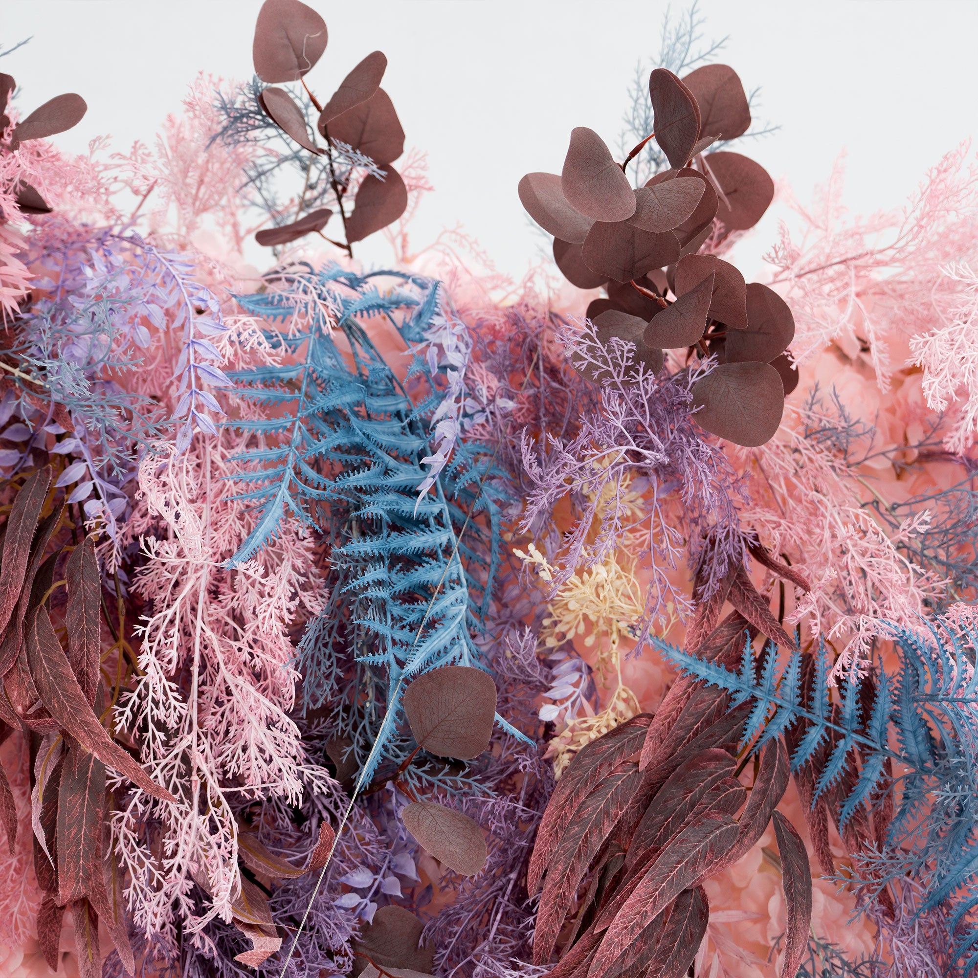 Event backdrop featuring roll-up 5D artificial florals in blush pink and lavender shades