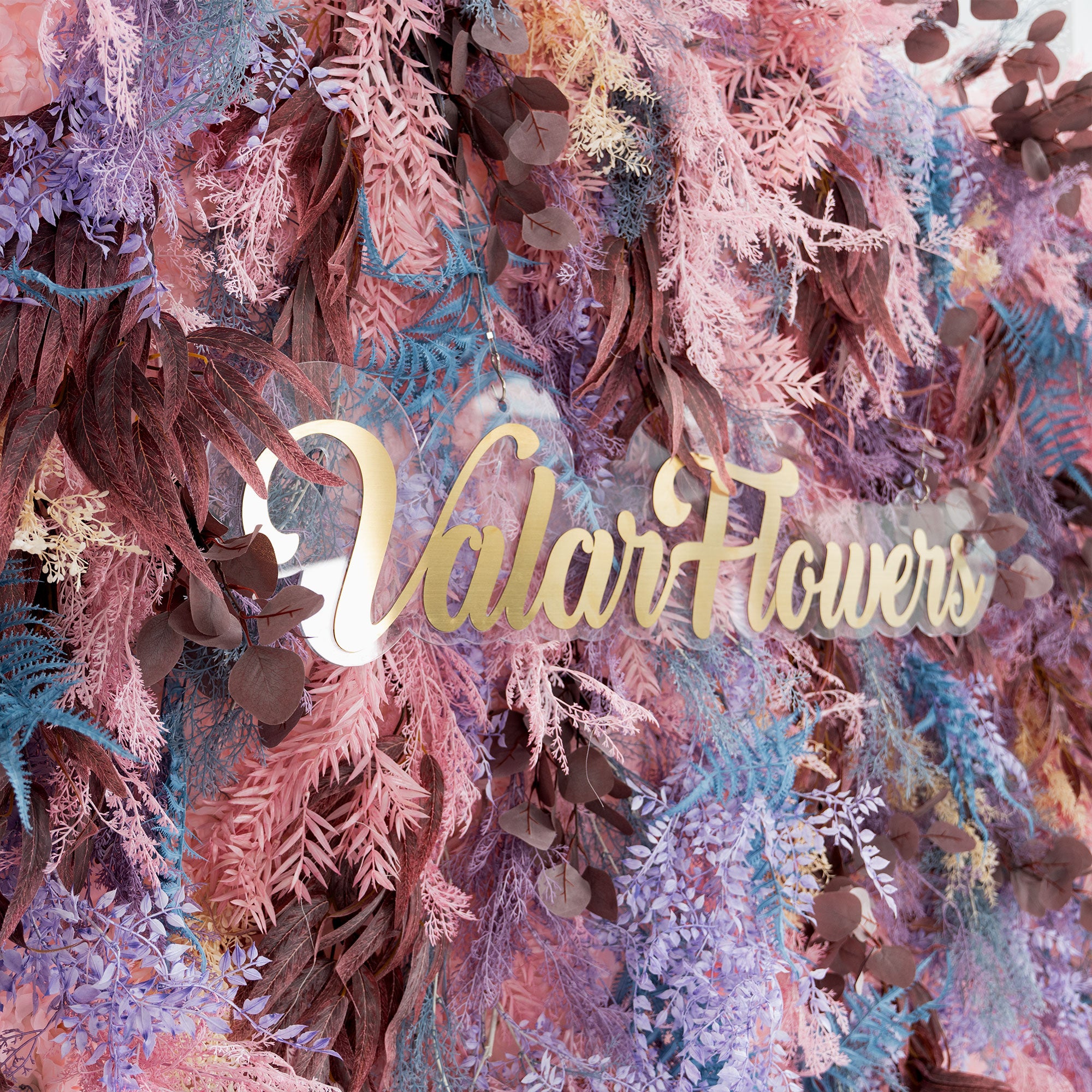 Romantic wedding backdrop with pink, purple, and burgundy artificial flower textures