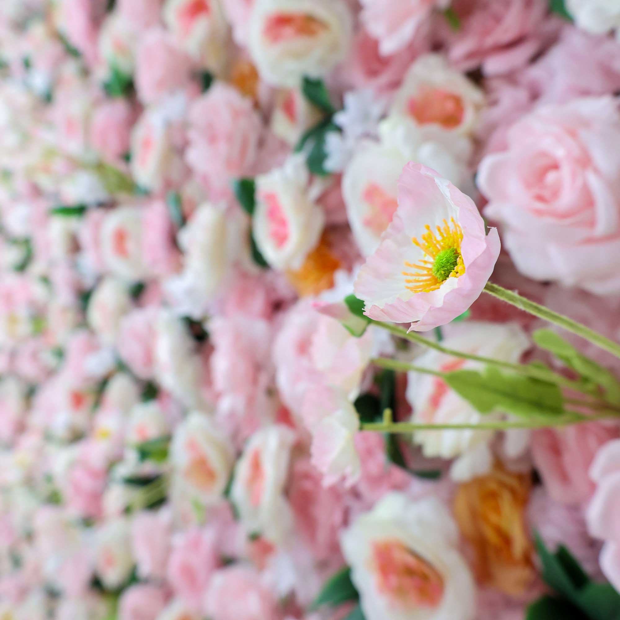 Handcrafted 5D artificial flower wall backdrop with soft pink and peach roses, accented with green leaves, set against a light background. Ideal for weddings, celebratory events, and photoshoots, adding a cheerful and inviting ambiance. VF-413-4