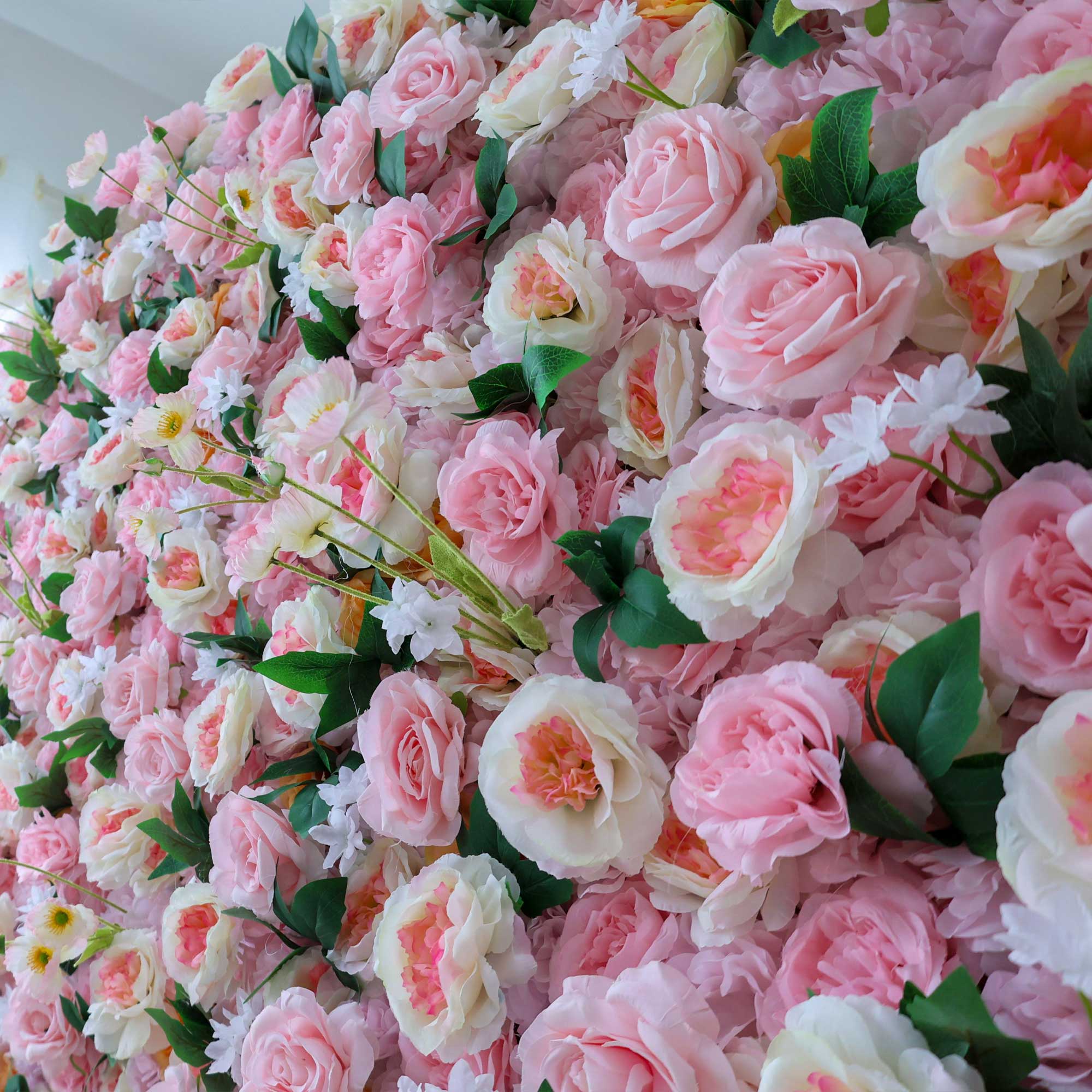 Handcrafted 5D artificial flower wall backdrop with soft pink and peach roses, accented with green leaves, set against a light background. Ideal for weddings, celebratory events, and photoshoots, adding a cheerful and inviting ambiance. VF-413-5