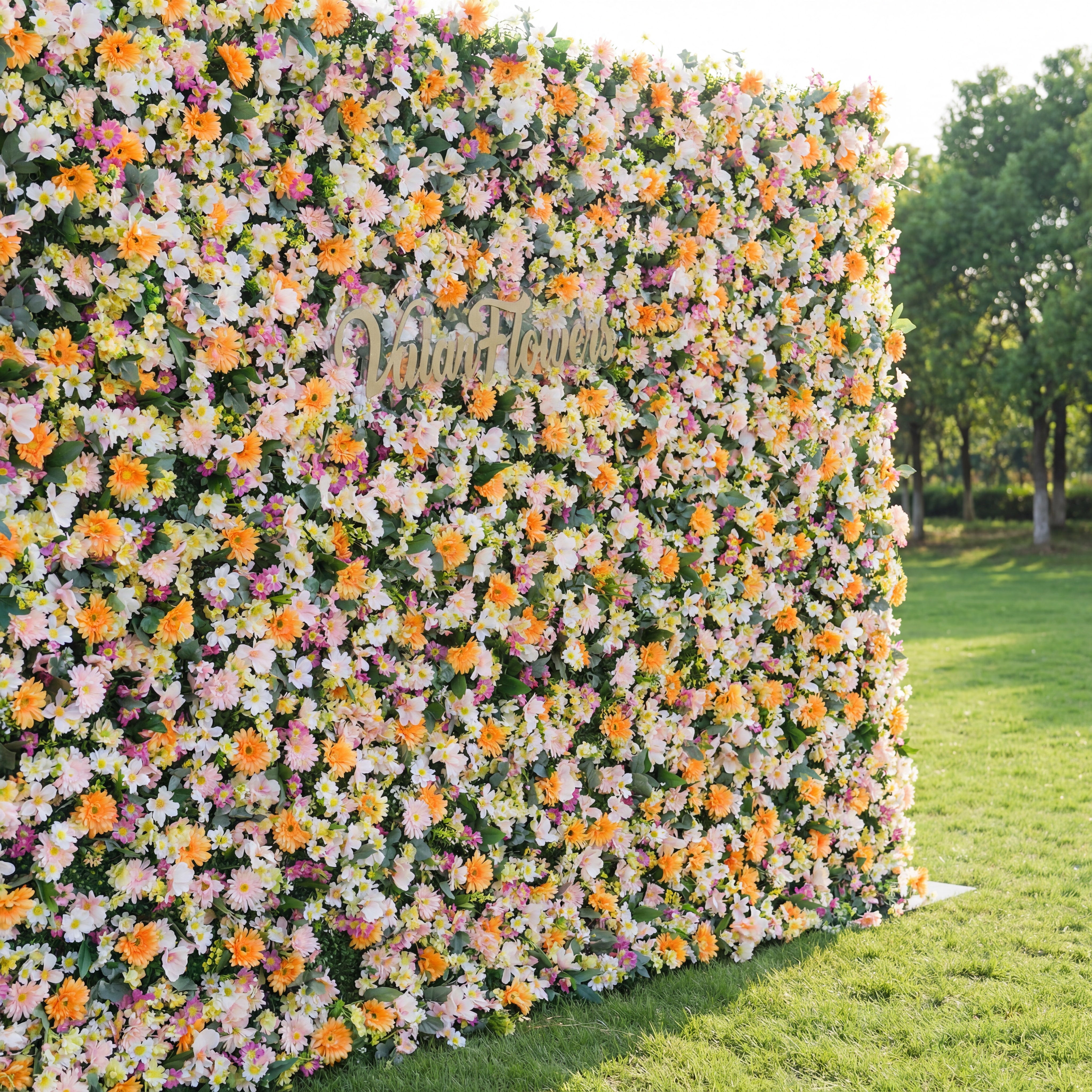 Floral wall with 'Walt Disney' logo in a garden setting