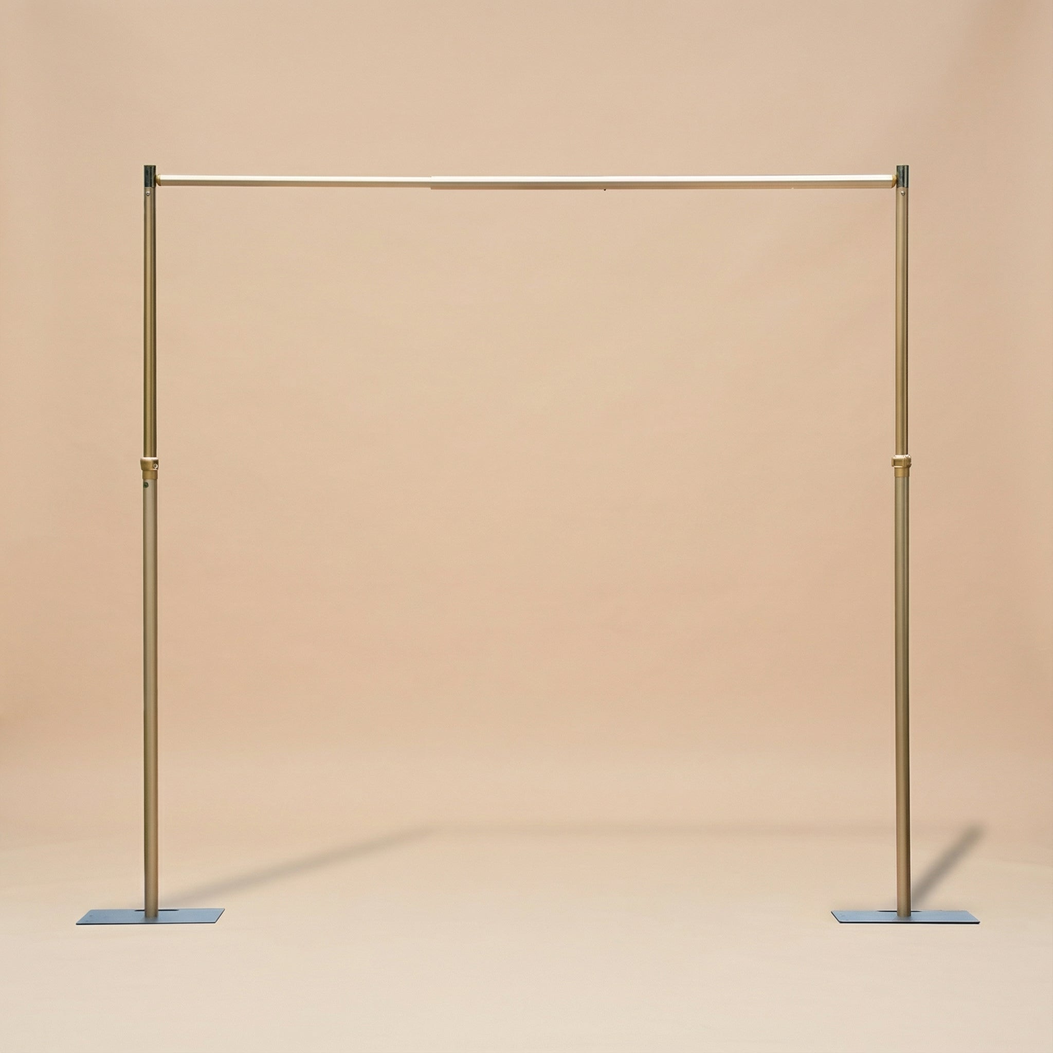 Gold clothing rack on a beige background
