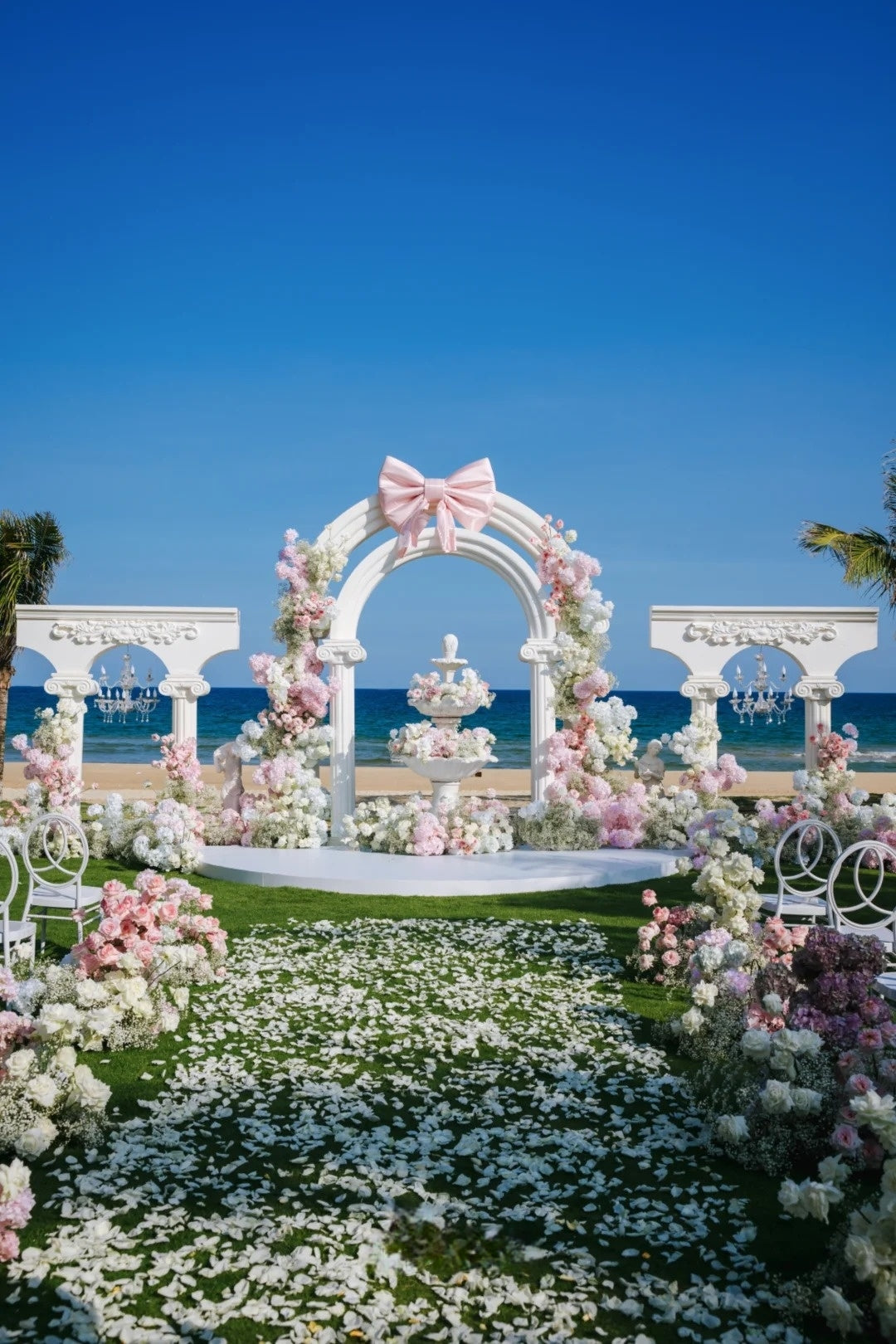Pink and White Seaside Wedding Ceremony with Bow Arch