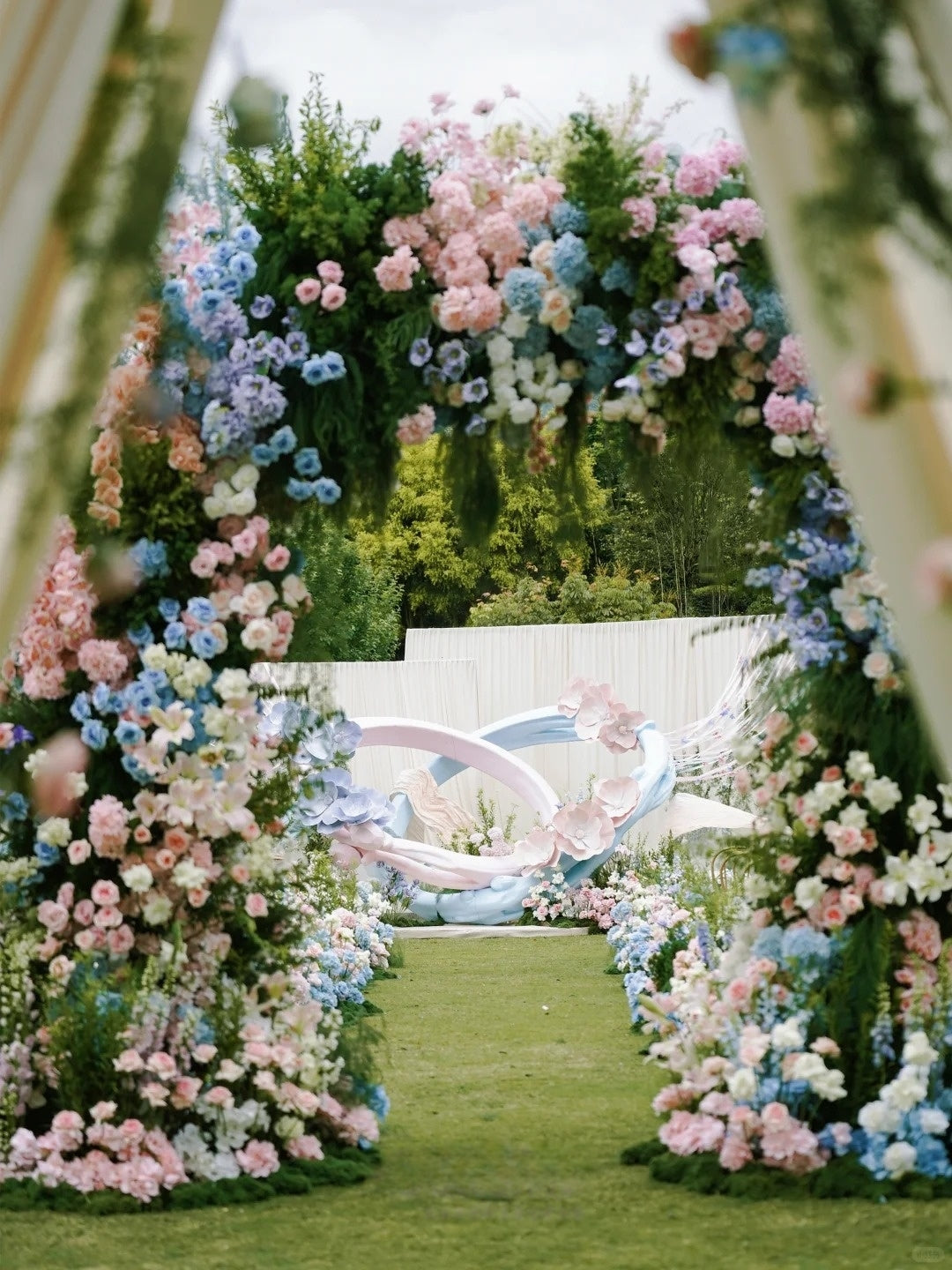 Pastel Garden Wedding Inspiration with Floral Arches and Romantic Bow Decor
