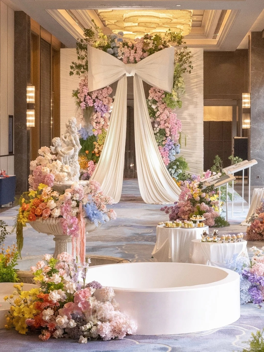 Romantic Indoor Wedding Inspiration with an Oversized Bow Entrance and Pastel Floral Decor