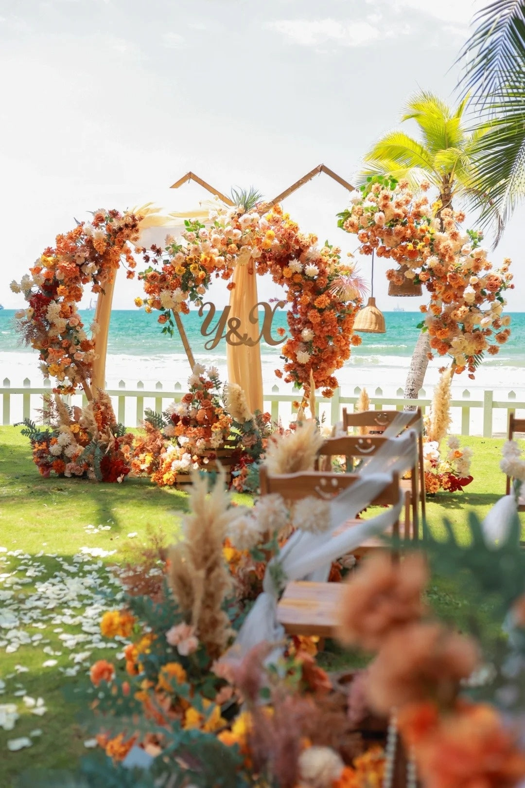 Beach Wedding Inspiration with Orange Florals and Tropical Curved Arches