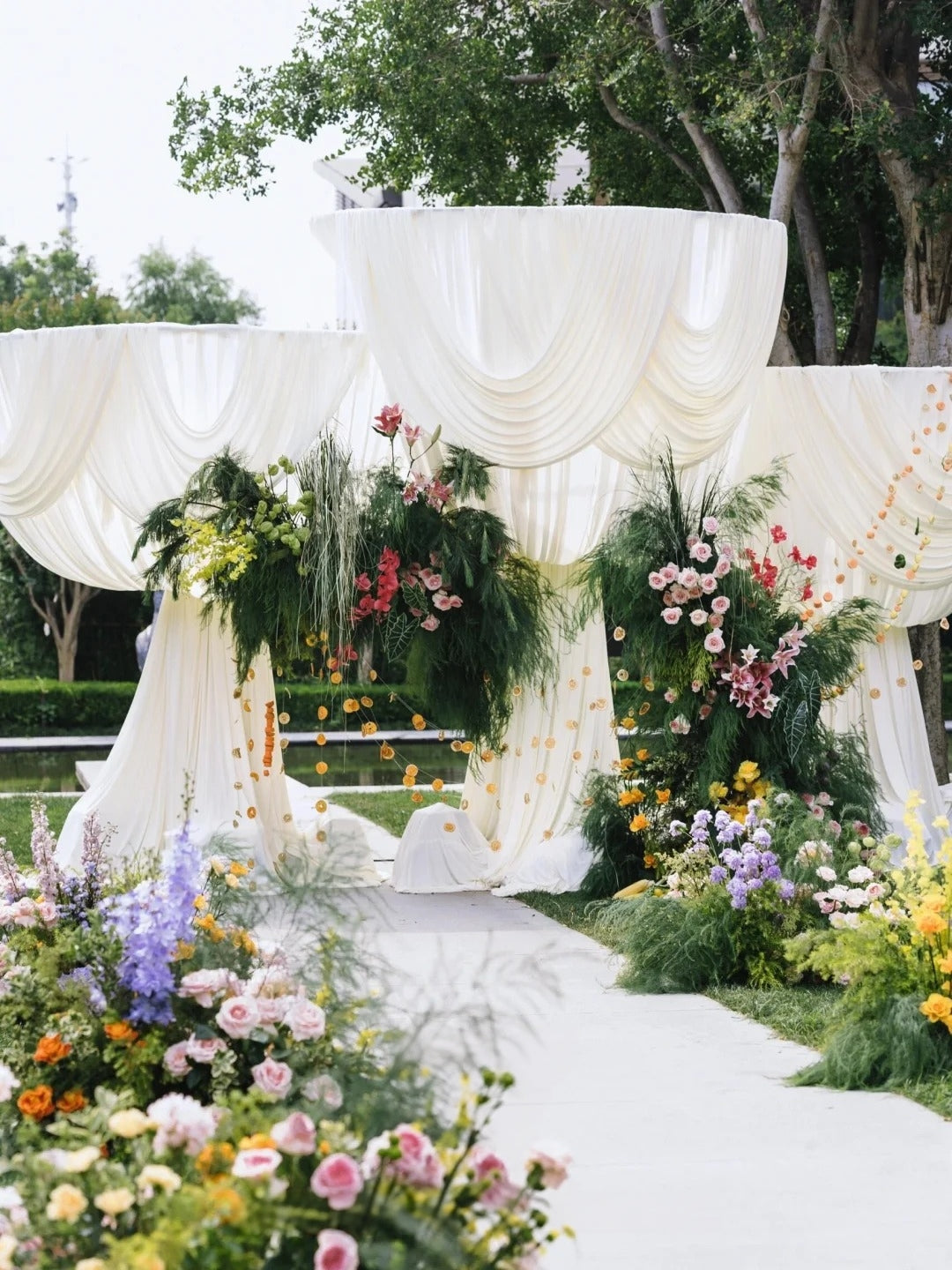 Romantic Garden Wedding with White Drapery, Oversized Bows and Colorful Florals