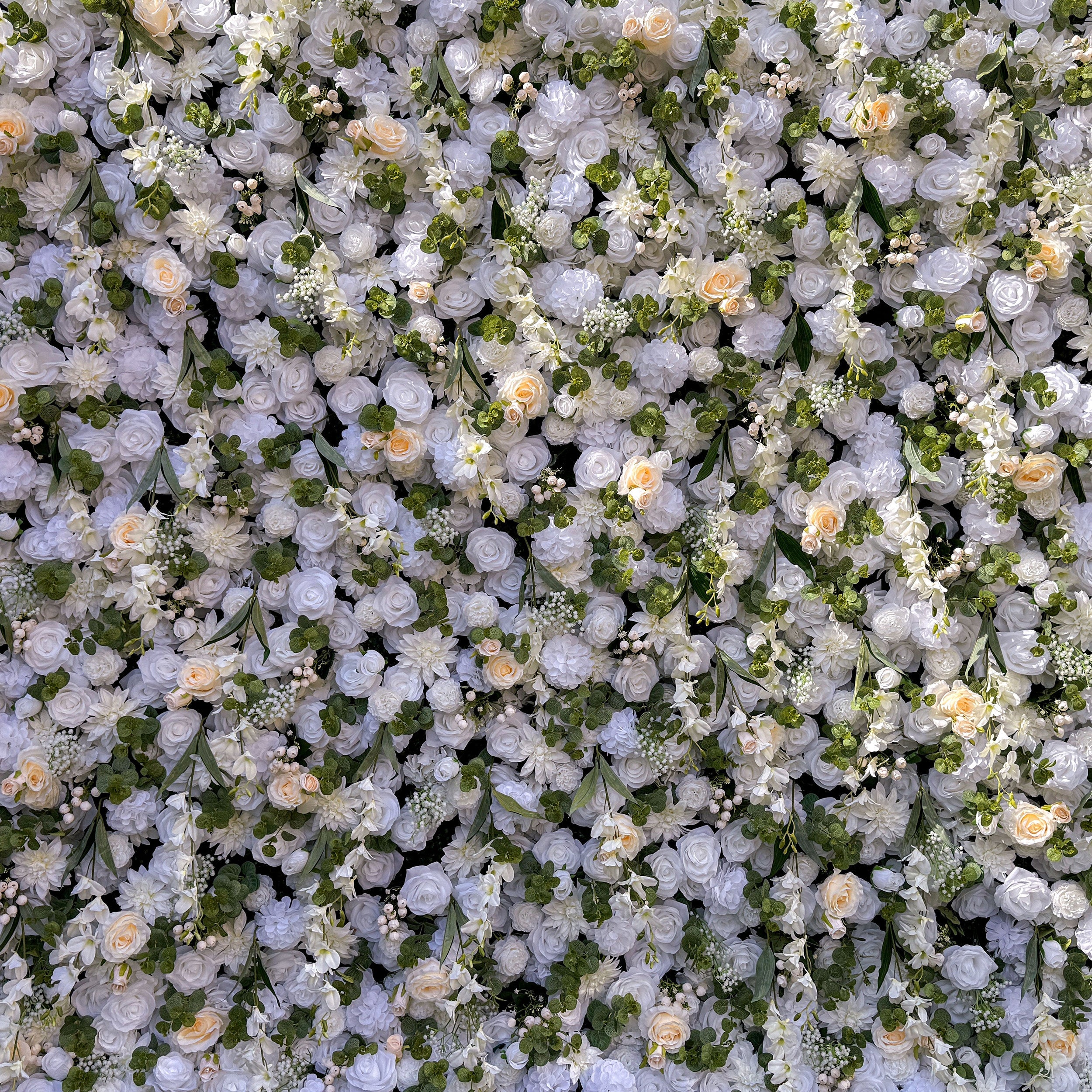 This wedding flower wall is a breathtaking sight. It is densely covered with a variety of white and light - colored flowers, such as roses and peonies. Interspersed among the flowers are lush green leaves and small floral buds, adding texture and depth. The overall effect is romantic and elegant, perfect for a wedding backdrop.