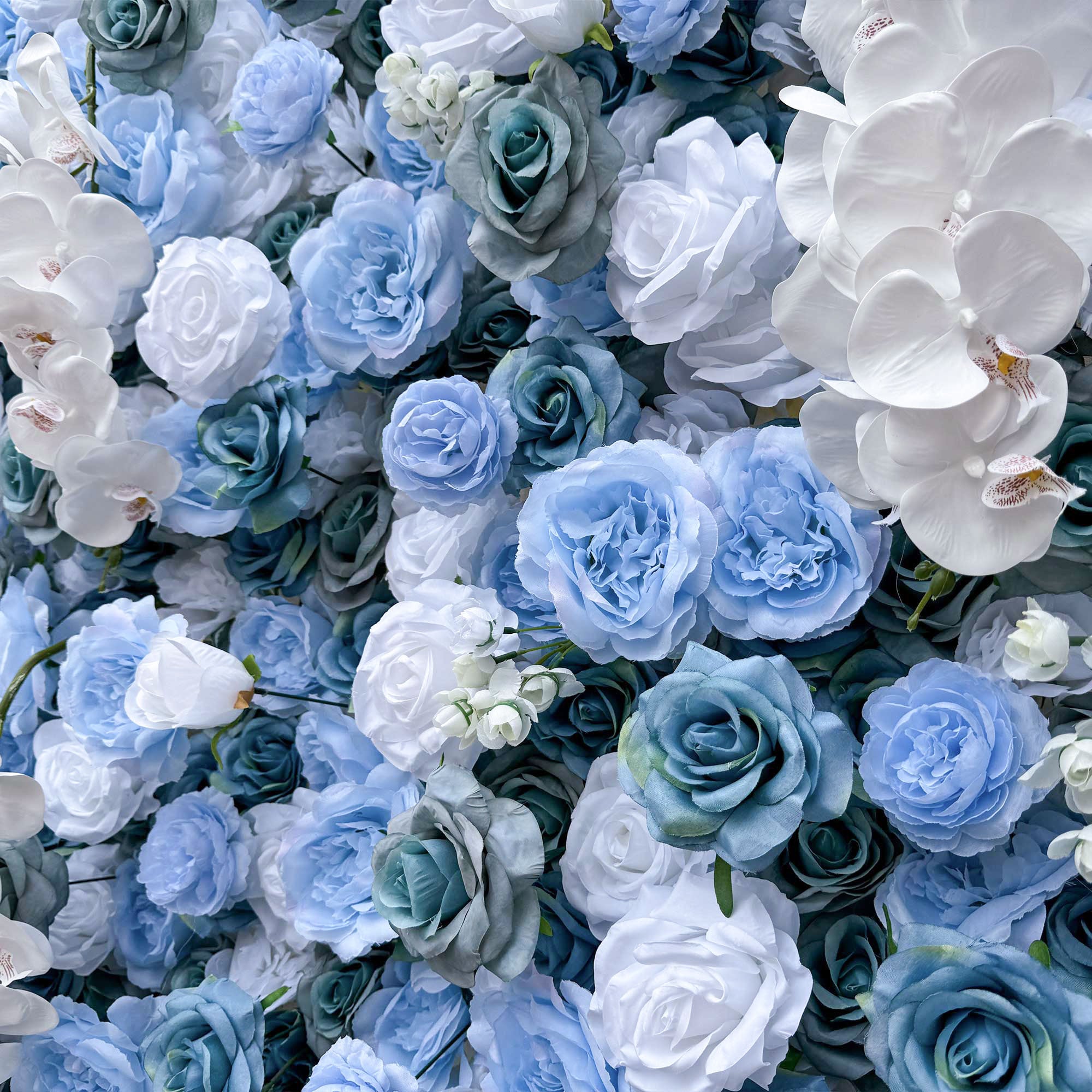 Elegant artificial flower wall featuring a blend of blue and white roses, set outdoors with greenery in the background, ideal for serene event decor. VF-348-4