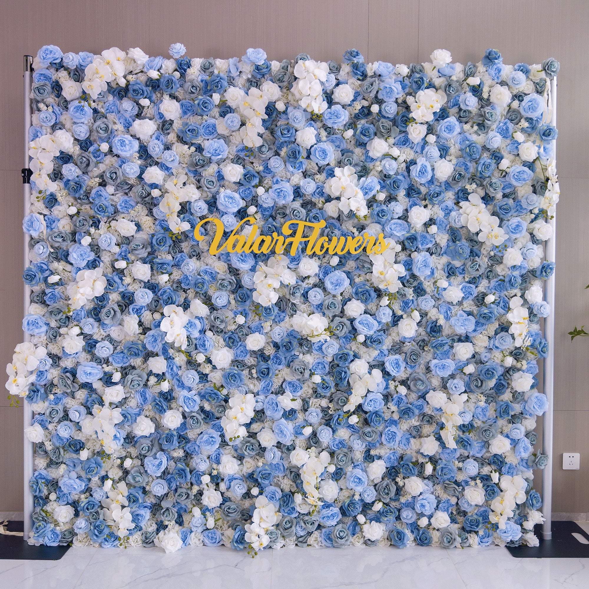 Elegant artificial flower wall featuring a blend of blue and white roses, set outdoors with greenery in the background, ideal for serene event decor. VF-348-5