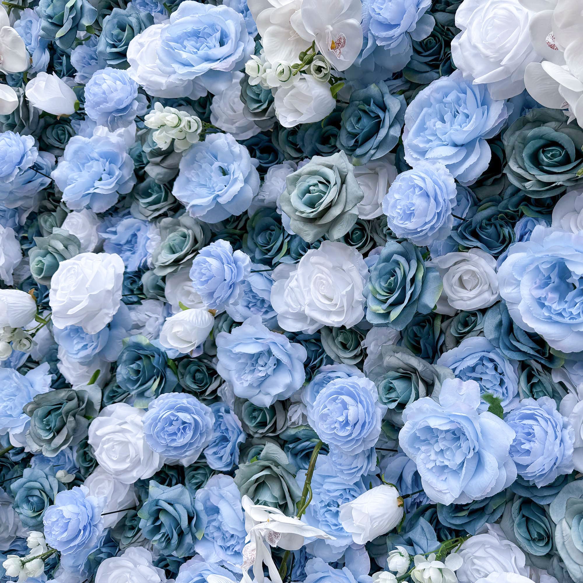 Elegant artificial flower wall featuring a blend of blue and white roses, set outdoors with greenery in the background, ideal for serene event decor. VF-348-7