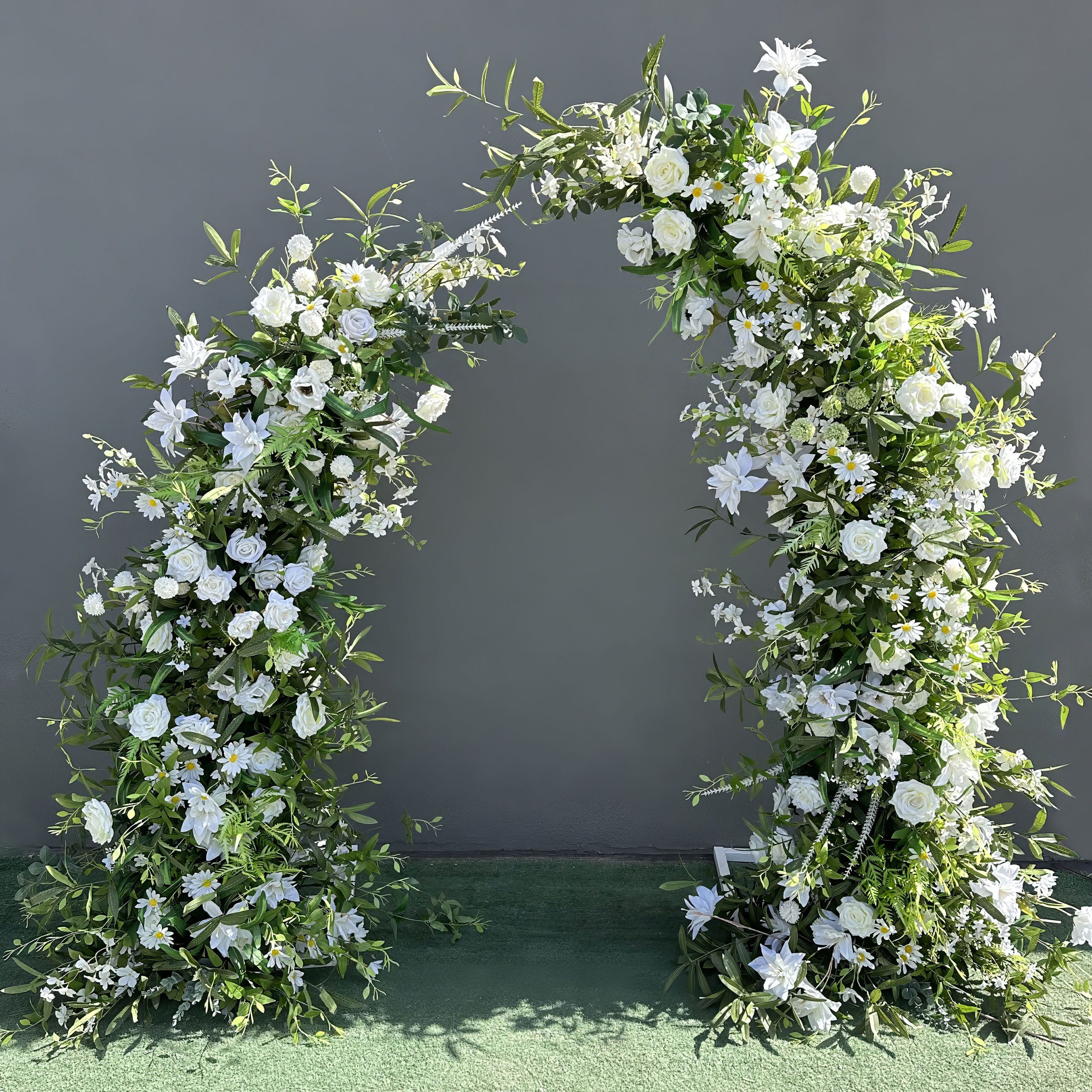 Beautifully crafted artificial floral arch for weddings, parties, and outdoor events. Features lush white flowers (roses, lilies, daisies) and green foliage on a sturdy frame. Ideal for ceremonies, photo backdrops, or entrances. Suitable for indoor and outdoor use. Elegant, timeless design.