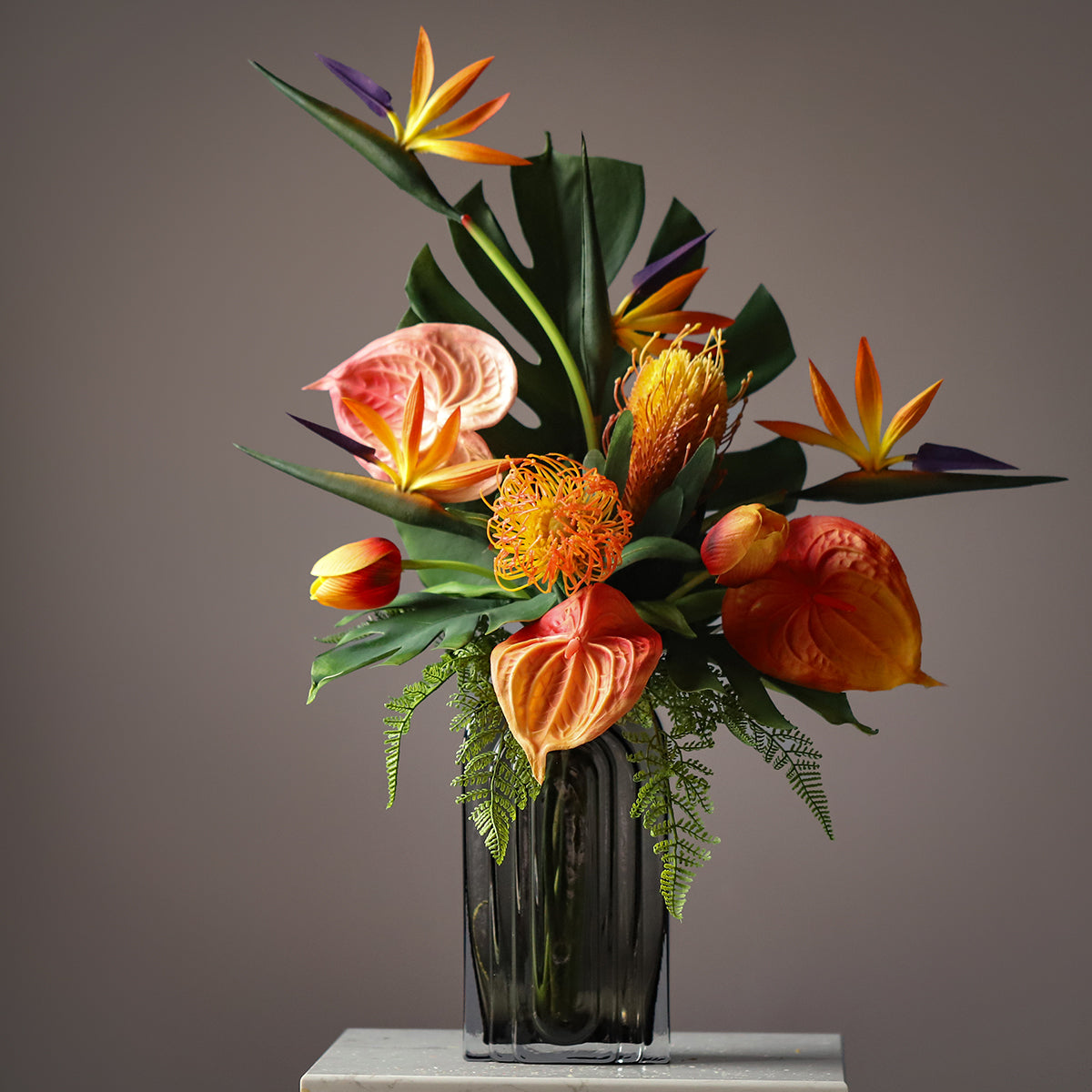 High-quality tropical silk floral arrangement with orange and green faux flowers, ideal for hotel, restaurant, and event décor.VB-104-2