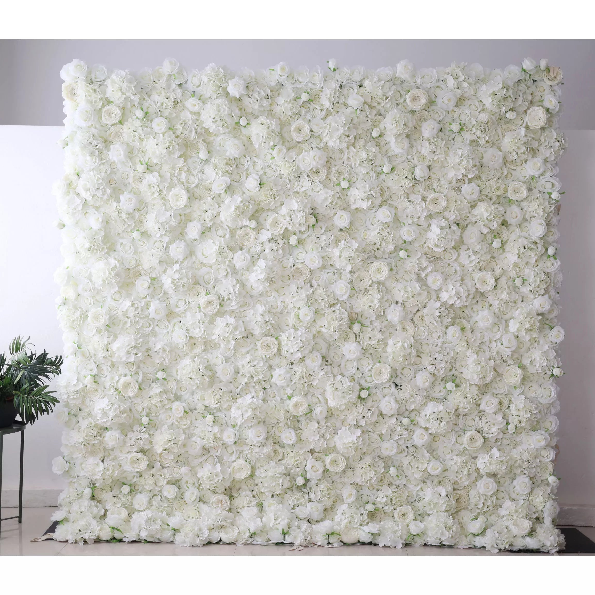 Valar Flowers' Artificial Fabric Flower Wall: Ethereal White Elegance. Immerse in an ocean of pure white blossoms; a luxurious arrangement that epitomizes classic beauty and sophistication, perfect for events desiring grace and angelic radiance.