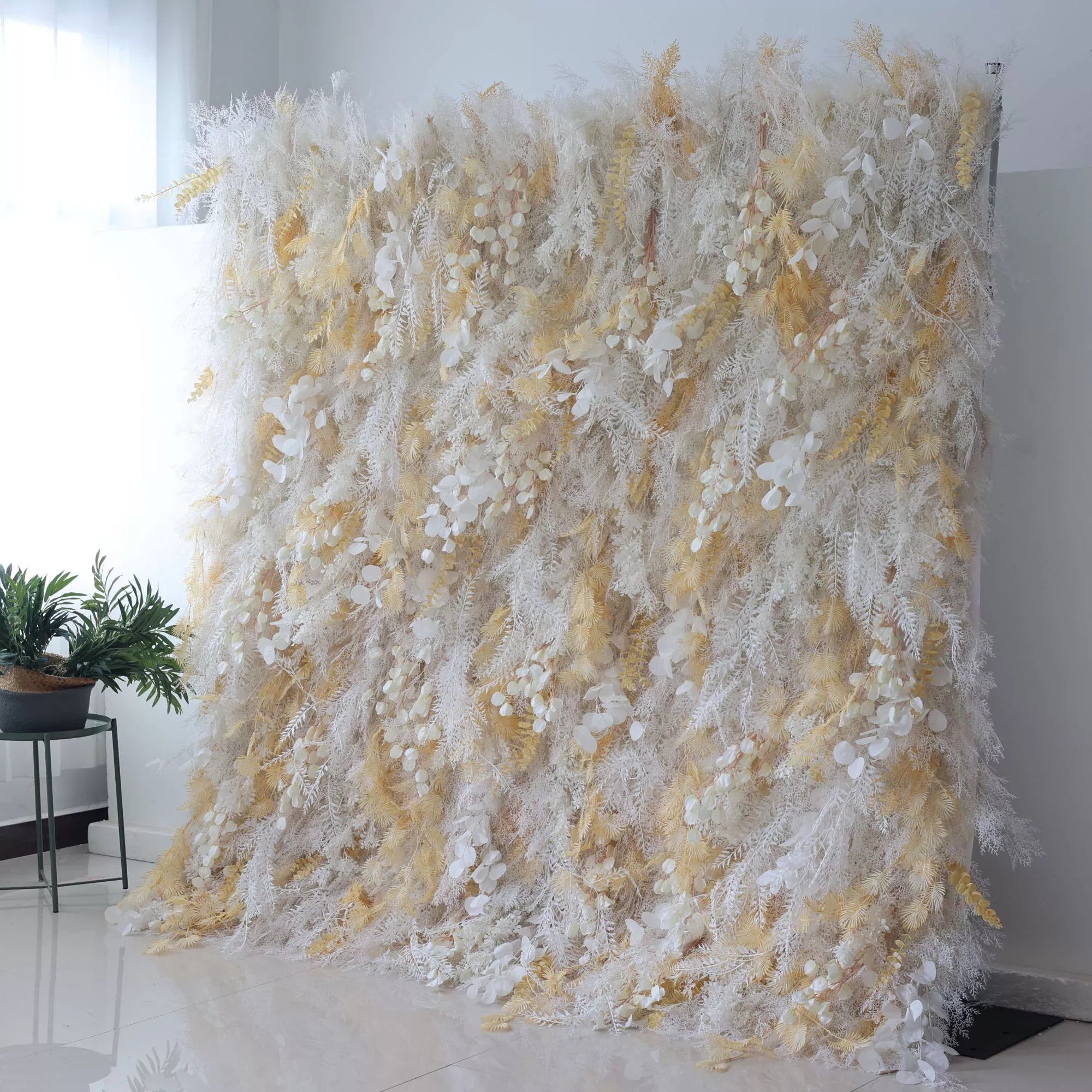 Introducing Valar Flowers' Artificial Fabric Flower Wall: Golden Gossamer Dreams. Soft white textures merge with shimmering gilded petals, creating a luminous display perfect for events radiating elegance and charm.